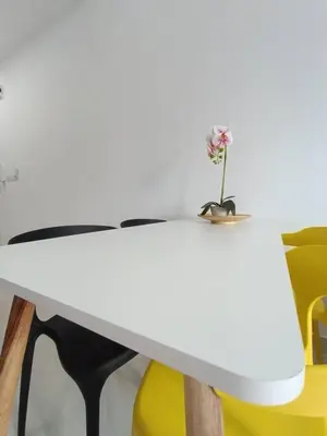 a white table with a flower on top of it at LUX 39A Balcony KLCC View 1 Bedroom Infinity Pool in Kuala Lumpur