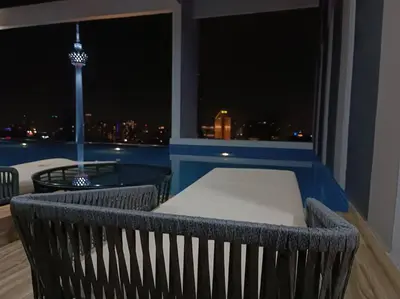 a balcony with a view of a city at night at LUX 39B KLCC view Studio in Kuala Lumpur