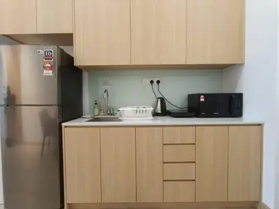 a kitchen with a refrigerator and a microwave at COL 27A KLCC View Infinity Pool View in Kuala Lumpur