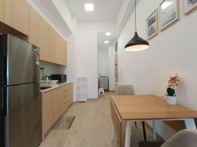 a kitchen and dining room with a table and a refrigerator at COL 27B KLCC View & Infinity Pool View in Kuala Lumpur