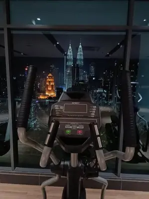 a camera in front of a window with a city at COL137A Modern Balcony KLCC View & Infinity Pool in Kuala Lumpur