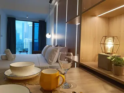 a room with a bed and a table with a wine glass at COL137A Modern Balcony KLCC View & Infinity Pool in Kuala Lumpur