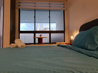 a bedroom with a large bed with a large window at COL 137B Modern Balcony KLCC View & Infinity Pool in Kuala Lumpur