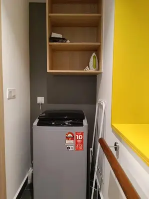 a small refrigerator in a small kitchen with a cabinet at COL 137B Modern Balcony KLCC View & Infinity Pool in Kuala Lumpur