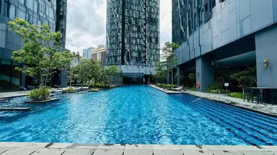 a large swimming pool in a city with tall buildings at Star Serviced Suite KLCC in Kuala Lumpur