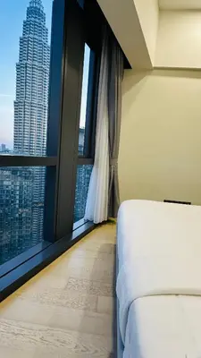 a bedroom with a bed and a large window at Star Serviced Suite KLCC in Kuala Lumpur