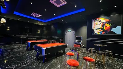 a room with a ping pong table and a big screen at Star Serviced Suite KLCC in Kuala Lumpur