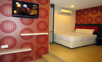 a room with a bed and a tv on a wall at T-Hotel Bukit Bintang in Kuala Lumpur