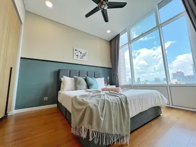 a bedroom with a bed with a ceiling fan at Sky Suites Leisure 3BR Suite at KLCC in Kuala Lumpur