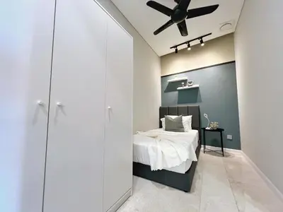 a bedroom with a bed and a ceiling fan at Sky Suites Leisure 3BR Suite at KLCC in Kuala Lumpur