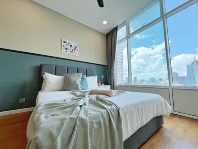 a bedroom with a large bed with a large window at Sky Suites Leisure 3BR Suite at KLCC in Kuala Lumpur