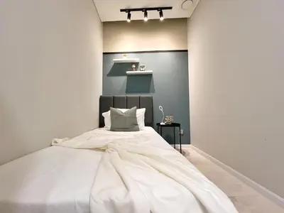 a bedroom with a large white bed in a room at Sky Suites Leisure 3BR Suite at KLCC in Kuala Lumpur
