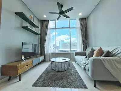 a living room with a couch and a large window at Sky Suites Leisure 3BR Suite at KLCC in Kuala Lumpur