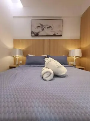 a bed with a white towel on top of it at COL 915A Modern Duplex Studio KLCC in Kuala Lumpur
