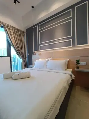 a bedroom with a large white bed with a window at COL 29A Cozy KLCC View & Infinity Pool in Kuala Lumpur
