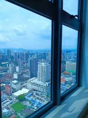 a view of a city from a window at COL 31A 1Bedroom Balcony Infinity Pool KLCC View in Kuala Lumpur
