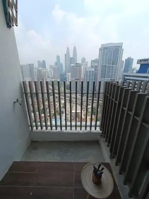 a balcony with a view of a city skyline at COL 23aA Cozy KLCC View & Infinity Pool Studio in Kuala Lumpur