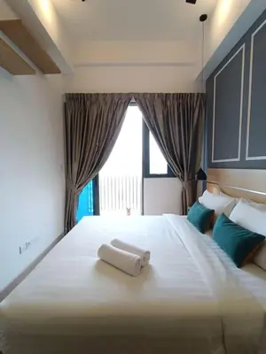 a large white bed with a towel on it at COL 23aB Cozy KLCC View & Infinity Pool Studio in Kuala Lumpur