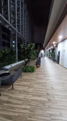 a hallway with benches and plants in a building at COL 23aB Cozy KLCC View & Infinity Pool Studio in Kuala Lumpur
