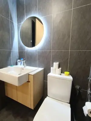a bathroom with a sink and a toilet and a mirror at COL 23aB Cozy KLCC View & Infinity Pool Studio in Kuala Lumpur