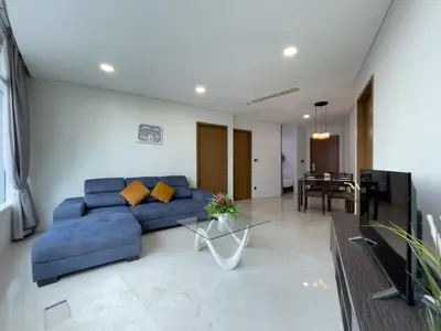 a living room with a blue couch and a table at Vortex Suites klcc By Sayang in Kuala Lumpur