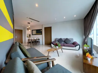 a living room with couches and a dining room at Vortex Suites klcc By Sayang in Kuala Lumpur