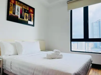a bedroom with a white bed with a large window at KL Homestay at Casa Residency- Walk to Lalaport & LRT in Kuala Lumpur