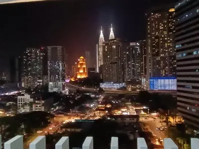 a view of a city at night with at COL 93A 2Queen bed Balcony KLCC View Family Suites in Kuala Lumpur