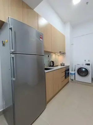 a kitchen with a refrigerator and a washer and dryer at COL 93A 2Queen bed Balcony KLCC View Family Suites in Kuala Lumpur