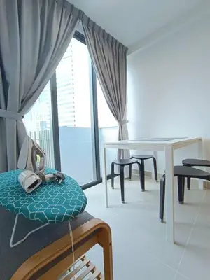 a room with a table and a chair and a table at COL 93A 2Queen bed Balcony KLCC View Family Suites in Kuala Lumpur