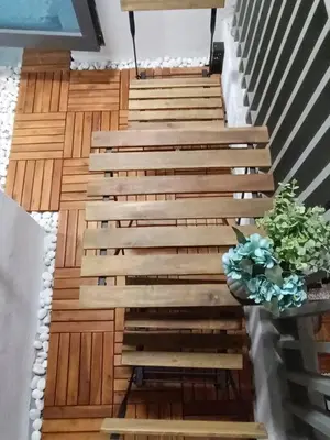 a staircase in a house with a potted plant at COL 93B Balcony KLCC View & Infinity Pool Studio in Kuala Lumpur