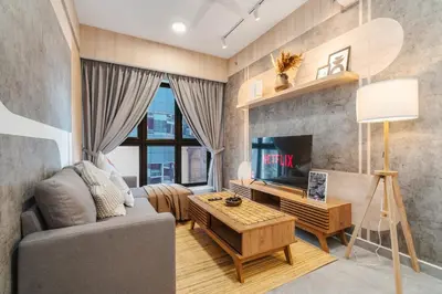 a living room with a couch and a tv at Japandi 1BR Agile Bukit Bintang by RumaBnB in Kuala Lumpur