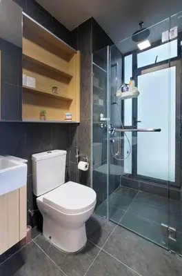 a bathroom with a toilet and a glass shower at COL25A KL Tower Balcony 1Bedroom & Infinity Pool KLCC View in Kuala Lumpur