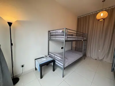 a room with two bunk beds and a table at Hushed Dorm KL in Kuala Lumpur