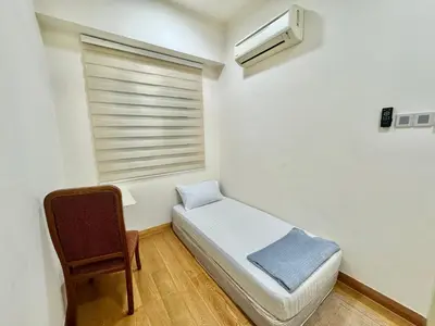a small bedroom with a bed and a window at Hushed Dorm KL in Kuala Lumpur