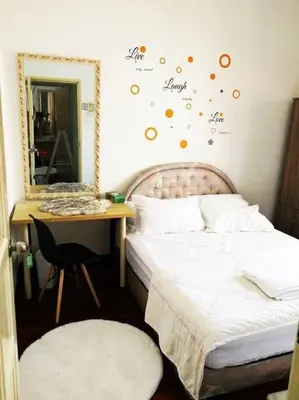 a bedroom with a bed and a desk and a mirror at Kuala Lumpur Homestay Bandar Sri Permaisuri in Kuala Lumpur