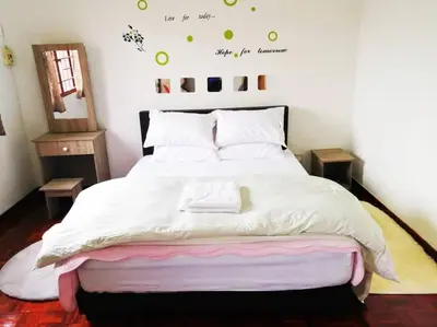 a bedroom with a large bed with white sheets at Kuala Lumpur Homestay Bandar Sri Permaisuri in Kuala Lumpur