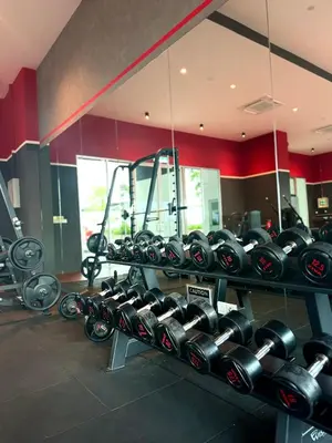 a rack of dumbbells in a gym at Studio Stay in Kuala Lumpur