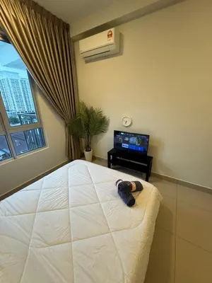 a bedroom with a large white bed and a window at Studio Stay in Kuala Lumpur