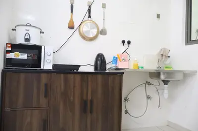 a kitchen with a microwave and a sink at Cozy kenwingston Platz KL 2-5 pax 2BR&2BR genting view parkin netflix 3802 in Kuala Lumpur