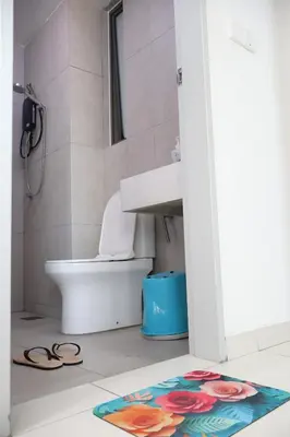 a bathroom with a toilet and a sink and a rug at Cozy kenwingston Platz KL 2-5 pax 2BR&2BR genting view parkin netflix 3802 in Kuala Lumpur