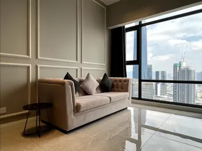 a living room with a couch and a large window at KL Suites Axon Residence - Wi-Fi 500Mbph in Kuala Lumpur
