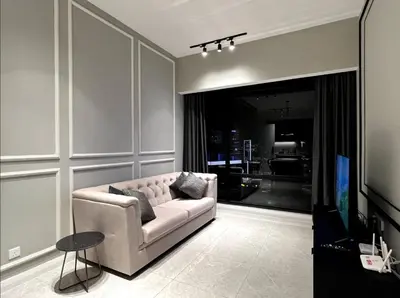 a living room with a couch and a tv at KL Suites Axon Residence - Wi-Fi 500Mbph in Kuala Lumpur