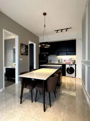 a kitchen and dining room with a table and chairs at KL Suites Axon Residence - Wi-Fi 500Mbph in Kuala Lumpur