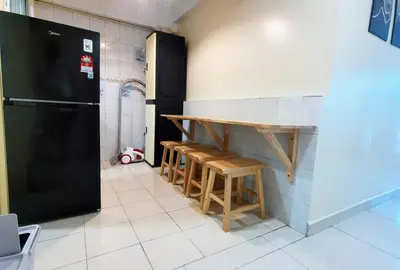 a kitchen with a counter and a table and a refrigerator at Tatami MUJI Relax 5p City center Staycation MRT in Kuala Lumpur