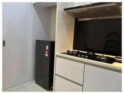 a kitchen with a black refrigerator and a stove at Setapak Central Premium Suites in Kuala Lumpur