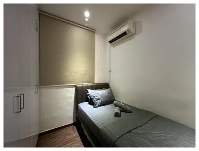 a small bedroom with a bed and a window at Setapak Central Premium Suites in Kuala Lumpur
