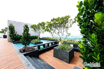 a garden with potted plants and a swimming pool at 24h Check in & SkyPool- KL Sentral Suite Riveria City Near KL Sentral KL KLCC in Kuala Lumpur