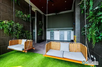 a porch with two wicker swinging chairs on a patio at 24h Check in & SkyPool- KL Sentral Suite Riveria City Near KL Sentral KL KLCC in Kuala Lumpur