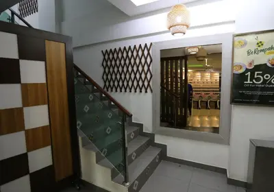 a hallway with a staircase and a mirror in a store at ECO Hotel at BBCC in Kuala Lumpur